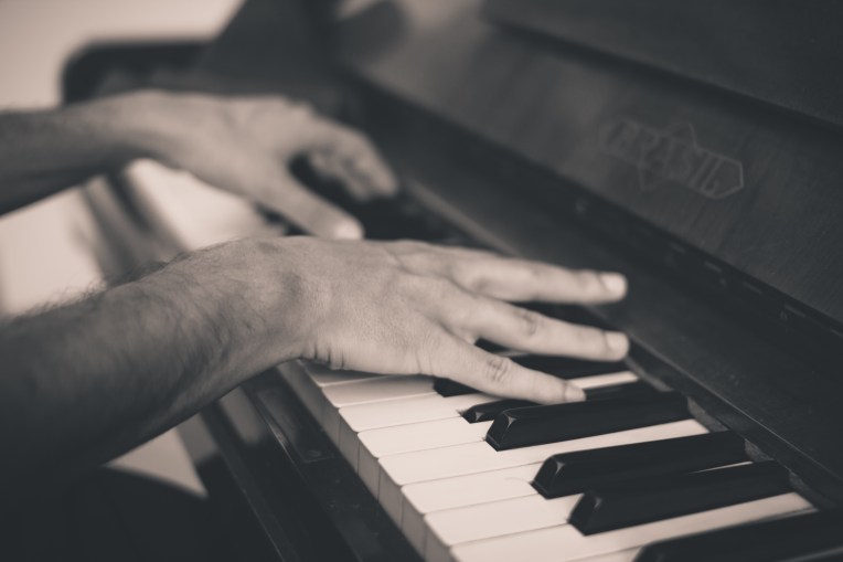 The hands of a man playing the piano